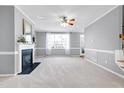 Bright living room with fireplace and neutral carpeting at 109 Stoneline Ct, Holly Springs, NC 27540