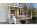 Front porch with white railings, columns, and steps leading to the front door at 125 Talley Ridge Dr, Holly Springs, NC 27540