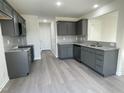 Modern kitchen with gray cabinets, granite countertops, and stainless steel appliances at 171 Wynd Crest Way, Benson, NC 27504