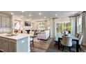 Bright dining area with table and chairs near kitchen and living room at 1878 Sweet Gardenia Way, Apex, NC 27502