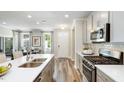 Modern kitchen with stainless steel appliances and a large island at 1878 Sweet Gardenia Way, Apex, NC 27502