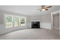 Living room with fireplace, wood-look floors, and bay window at 262 Homestead Dr, Selma, NC 27576