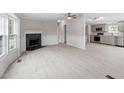 Open living room with fireplace, wood-look flooring, and ample natural light at 262 Homestead Dr, Selma, NC 27576