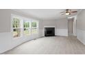Bright living room featuring a fireplace and large windows at 262 Homestead Dr, Selma, NC 27576