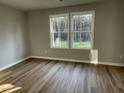 Bright bedroom with hardwood floors and two large windows at 309 Magnolia Run Way, Benson, NC 27504