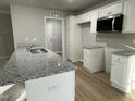 Modern kitchen with granite countertops and white cabinetry at 309 Magnolia Run Way, Benson, NC 27504