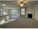 Spacious living room featuring a fireplace and plush carpeting at 309 Magnolia Run Way, Benson, NC 27504
