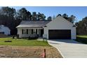 New construction home features a neutral color palette and a two-car garage at 359 Magnolia Run Way, Benson, NC 27504