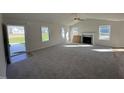 Bright living room features a fireplace and access to the kitchen at 359 Magnolia Run Way, Benson, NC 27504