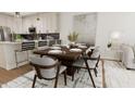 Elegant dining area with a wood table and gray chairs at 4075 Elk Creek Ln # 9, Raleigh, NC 27612