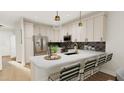 Modern kitchen with island seating and stainless steel appliances at 4075 Elk Creek Ln # 9, Raleigh, NC 27612