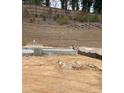Construction site showing foundation work and landscape retaining wall under construction at 4077 Elk Creek Ln, Raleigh, NC 27612