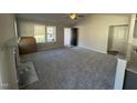 Spacious living room featuring gray carpeting, a fireplace, and ample natural light at 411 Magnolia Run Way, Benson, NC 27504