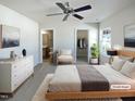 Virtually staged bedroom with large bed, dresser, and ensuite bathroom at 5211 Blue Lagoon Ln, Raleigh, NC 27610