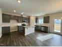 Modern kitchen featuring gray cabinets and granite island at 554 Eversden Dr, Zebulon, NC 27597