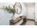 Bright entryway with wood console table, mirror, and vase at 70 Saddle Mare St, Clayton, NC 27520
