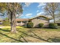 House exterior showcasing a brick facade and well-maintained lawn at 103 Marion Dr, Erwin, NC 28339