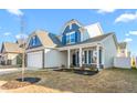 Two-story light gray house with dark blue shutters and a two-car garage at 1039 Brockton Dr, Mebane, NC 27302