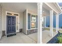 Front porch with white columns and a dark blue front door at 1039 Brockton Dr, Mebane, NC 27302