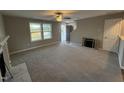 Spacious living room featuring carpet, fireplace, and ceiling fan at 228 Mahogany Way, Four Oaks, NC 27524