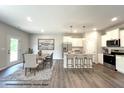 Virtually staged kitchen features modern appliances, an island, and a dining area at 243 Danube Dr, Zebulon, NC 27597