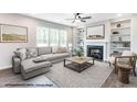 Virtually staged living room with fireplace, built-in shelving, and comfortable seating at 243 Danube Dr, Zebulon, NC 27597