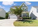 Two-story craftsman home with front porch and landscaped lawn at 296 Two Creeks Lp, Chapel Hill, NC 27517