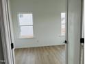 Bright bedroom with two windows, hardwood floors, and neutral colors at 4327 Emeline Way # 10, Fuquay Varina, NC 27526