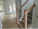 Elegant staircase featuring wood and black metal accents leading to the upper level at 4327 Emeline Way # 10, Fuquay Varina, NC 27526
