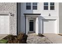 Close up of a new construction home's front entrance with dark door and attached one car garage at 545 Eversden Dr, Zebulon, NC 27597