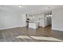 Open concept kitchen featuring white cabinets, stainless steel appliances, and a central island with a breakfast bar at 556 Eversden Dr, Zebulon, NC 27597
