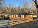 Brick ranch house with carport, driveway and spacious yard at 6416 Diamond Dr, Raleigh, NC 27610