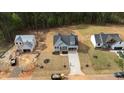 Expansive aerial view of new home construction in a tree-filled lot with an extended drive way at 95 Purslane Dr, Franklinton, NC 27525