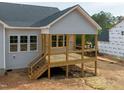 A spacious back deck with natural wood floors and black railings, perfect for outdoor entertaining at 95 Purslane Dr, Franklinton, NC 27525