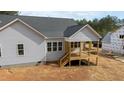 Side view of a home featuring a cozy porch and back windows, showcasing the architectural design at 95 Purslane Dr, Franklinton, NC 27525