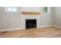 Close up of modern fireplace with light wood mantel and shiplap wall at 95 Purslane Dr, Franklinton, NC 27525
