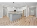 Well-lit kitchen showcases white cabinets, large island, and stainless appliances at 95 Purslane Dr, Franklinton, NC 27525