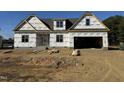 New construction home with a two-car garage and vinyl siding at 129 Lassiter Ridge Dr, Four Oaks, NC 27524
