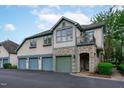 Three-car garage, stone accents, and a charming front entrance at 201 Presque Isle Ln, Chapel Hill, NC 27514