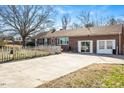 Front view of brick ranch home with driveway and picket fence at 2540 Mayo Lake Rd, Roxboro, NC 27574