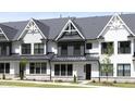 Charming modern farmhouse-style townhome featuring black window frames and a metal roof at 316 Church St, Morrisville, NC 27560
