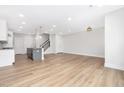 Open-concept living room with hardwood floors adjacent to a modern kitchen at 316 Church St, Morrisville, NC 27560