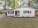 Charming single-story home with brick exterior, well-manicured lawn, and welcoming front porch at 3907 Inwood Dr, Durham, NC 27705