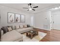 Living room featuring hardwood floors, a sectional sofa, and a coffee table at 3907 Inwood Dr, Durham, NC 27705