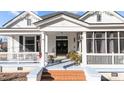 Inviting front porch with patriotic decor, classic columns, and a relaxing ambiance at 400 S Boddie St, Nashville, NC 27856