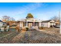 Cozy single-story home with a inviting front porch and well-maintained lawn at 408 W Main St, Pine Level, NC 27568