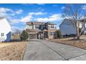 Two-story house with stone and siding, two-car garage, and driveway at 664 Long Melford Dr, Rolesville, NC 27571