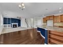 Open floor plan features a cozy fireplace, modern kitchen with granite countertops, and a staircase at 664 Long Melford Dr, Rolesville, NC 27571