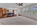 Bright and airy living room featuring large windows, hardwood floors, and seamless flow to the kitchen at 664 Long Melford Dr, Rolesville, NC 27571