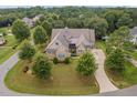Bird's eye view of a luxurious house with a circular driveway and lush landscaping at 7440 Bleasdale Ct, Apex, NC 27539